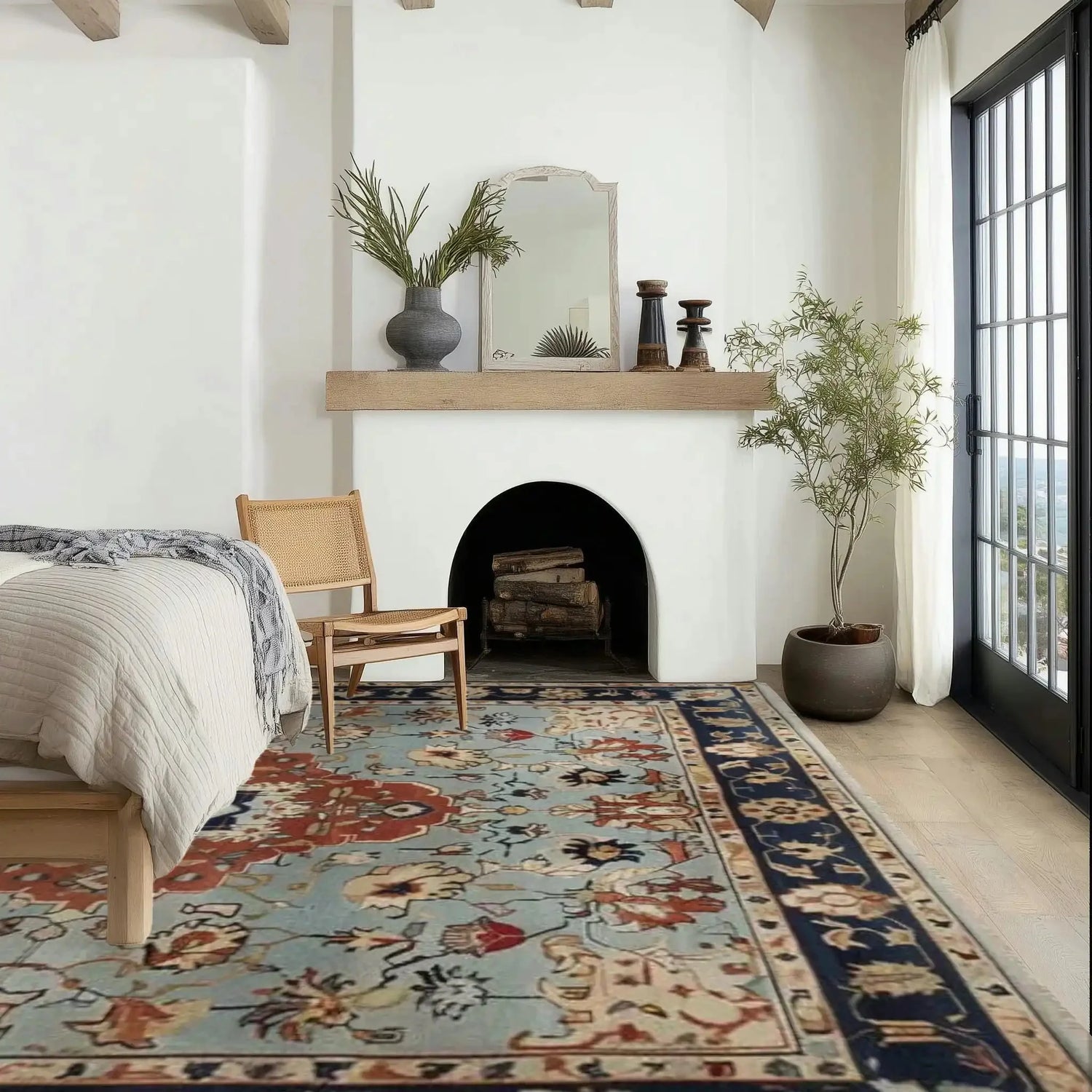 A beautifully styled living room featuring a Floral Cascade Blue Hand Knotted Area Rug. The vintage square area rug displays intricate Persian-inspired designs in shades of blue and red, perfect for enhancing large living room spaces. Its wool texture adds a touch of elegance and warmth to the room, complementing the modern decor and natural light pouring through the windows.