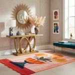 Modern interior with a gold console table, decorative mirror, and colorful rug.