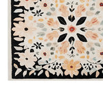 Close-up of the Floral Crown Hand Tufted Wool Rug showcasing its intricate floral pattern. This elegant area rug features a harmonious blend of soft colors like peach, cream, and black, making it a perfect addition to your living room. Ideal for those seeking an 8x10 living room rug with a stylish floral design, this wool rug brings warmth and charm to any space.