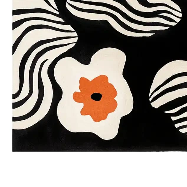 A stylish area rug showcasing a contemporary design with bold black and white wavy stripes and vibrant orange floral accents. This large wool rug is perfect for enhancing modern living room spaces with its unique and artistic pattern.