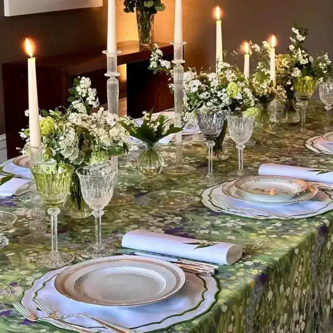 floral elegance placemats green botanical print full dinner table with gold-rimmed plates crystal stems white candle centerpieces