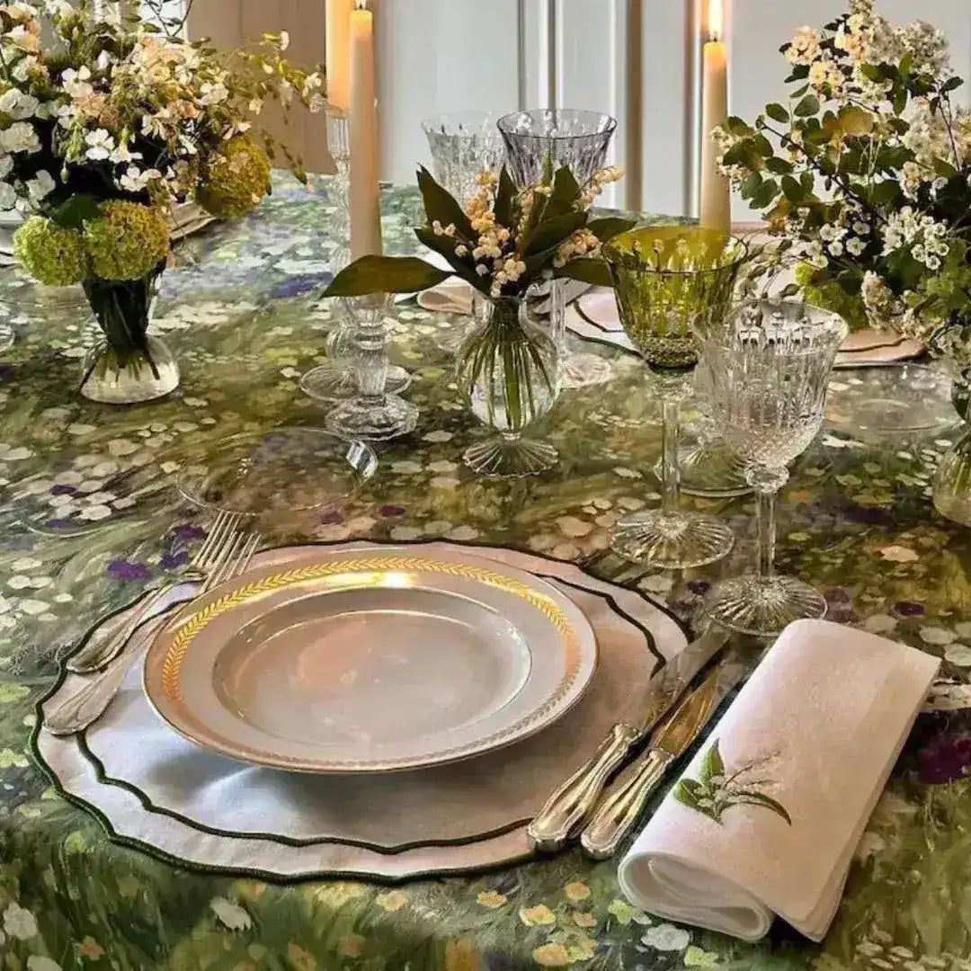 floral elegance placemat scalloped edge green botanical print stacked gold-trimmed plates crystal stemware linen napkin detail