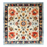 A beautifully crafted Floral Extravaganza Wool Hand Knotted Area Rug, featuring a vibrant floral design with intricate patterns in shades of red, blue, and orange. Perfect for enhancing the elegance of bedrooms, living rooms, and dining rooms, this wool rug exudes the timeless charm of Persian rugs.