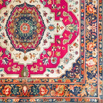 A vibrant Floral Fiesta Hand Knotted Area Rug featuring intricate Persian-inspired designs with bold pink, blue, and ivory hues. This square rug showcases a stunning central medallion surrounded by ornate floral patterns, perfect for adding a vintage touch to your living room or dining room. Ideal as a wool rug under a dining table or as a statement piece among rugs for the living room.