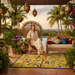 Woman sitting in a decorative chair on a floral rug, a patio with plants and a pool in the background