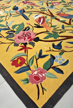 Decorative rug with floral and bird patterns on a yellow background