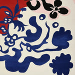 A vibrant area rug showcasing an abstract floral design with bold blue and red patterns on a neutral background, perfect for contemporary living room spaces. This large living room rug is hand-tufted from wool, combining modern artistry with comfort, ideal for enhancing any living room area.