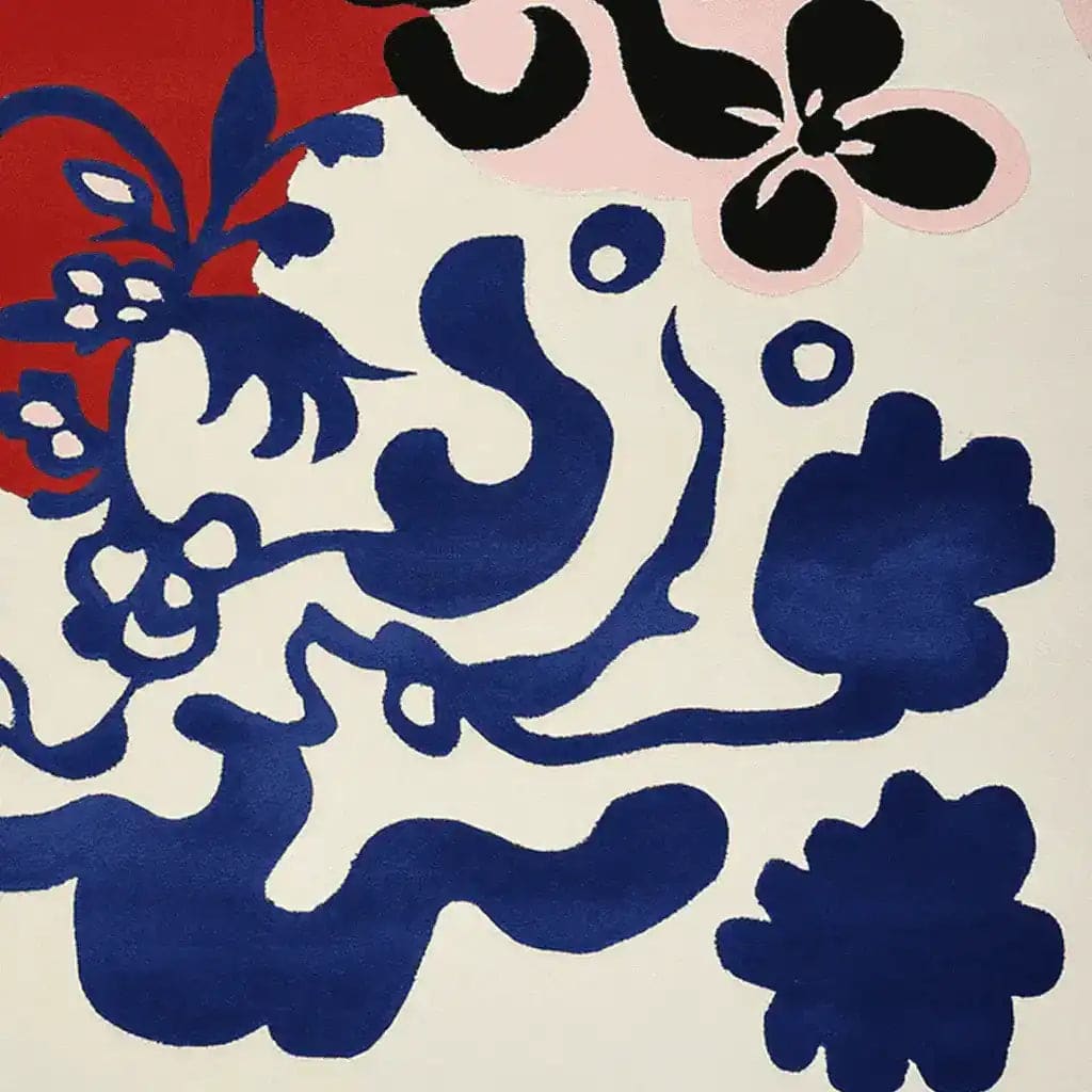 A vibrant area rug showcasing an abstract floral design with bold blue and red patterns on a neutral background, perfect for contemporary living room spaces. This large living room rug is hand-tufted from wool, combining modern artistry with comfort, ideal for enhancing any living room area.