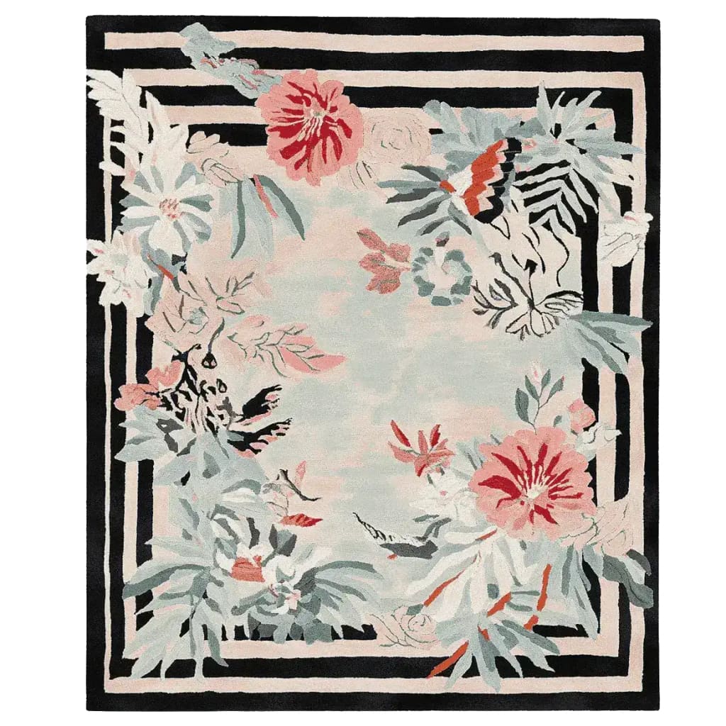Beautiful hand-tufted area rug with a floral frame design, perfect for adding elegance to a living room. The wool rug features vibrant flowers in red and pastel hues set against a contrasting black and white striped border.