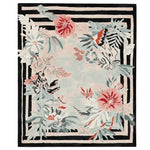 Beautiful hand-tufted area rug with a floral frame design, perfect for adding elegance to a living room. The wool rug features vibrant flowers in red and pastel hues set against a contrasting black and white striped border.