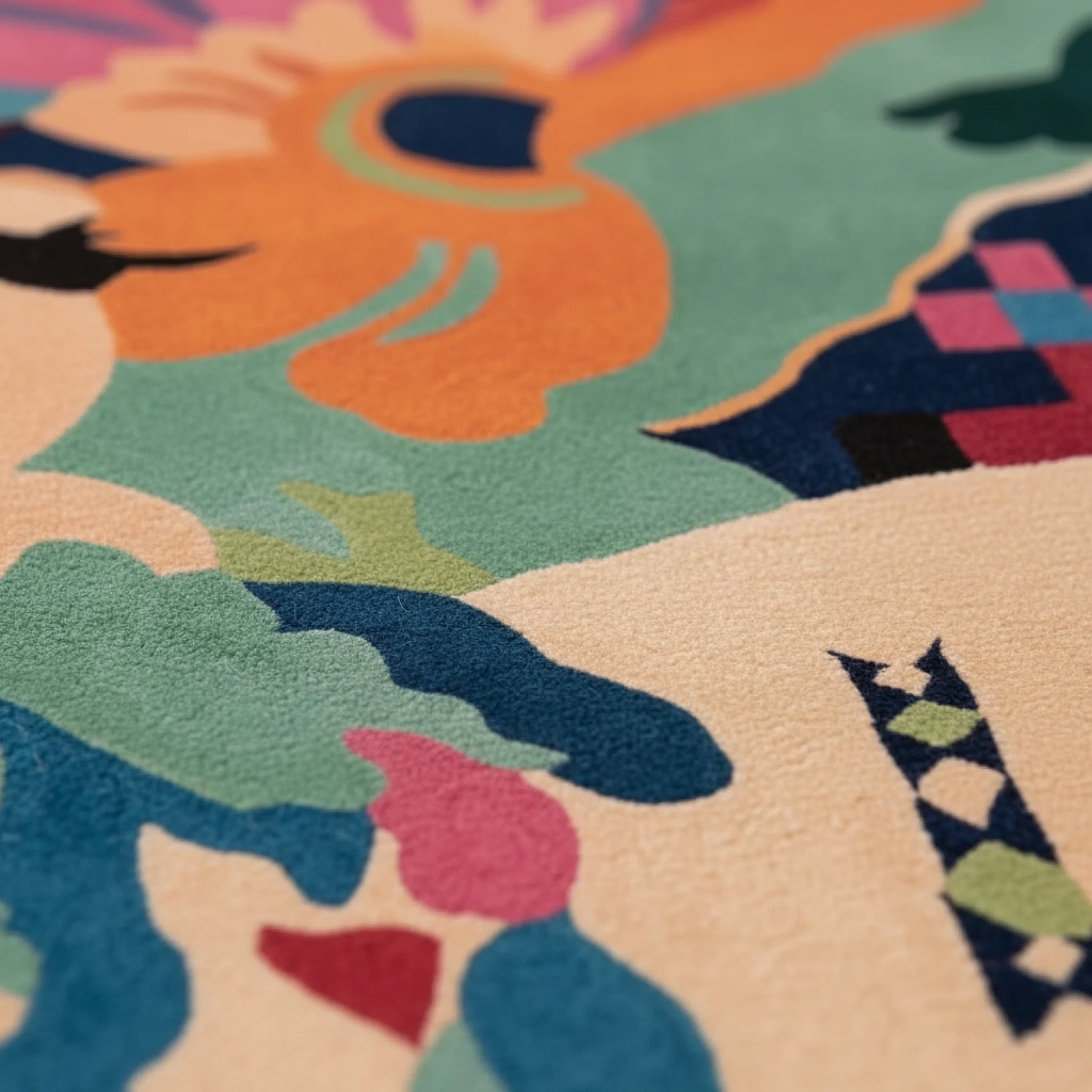 Close-up of a colorful patterned rug with abstract shapes and vibrant colors.