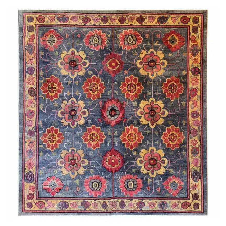 A beautifully crafted Floral Fusion Hand Tufted Rug, featuring a vibrant floral design with red, yellow, and blue hues. This square area rug is perfect for adding a touch of vintage charm to your office or living room. Made from high-quality wool, this large area rug combines durability with elegance, ideal for those seeking a floral rug that enhances any space.