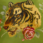 Floral green throw pillow featuring an embroidered tiger and roses, perfect for adding a touch of nature-inspired decor to your home.