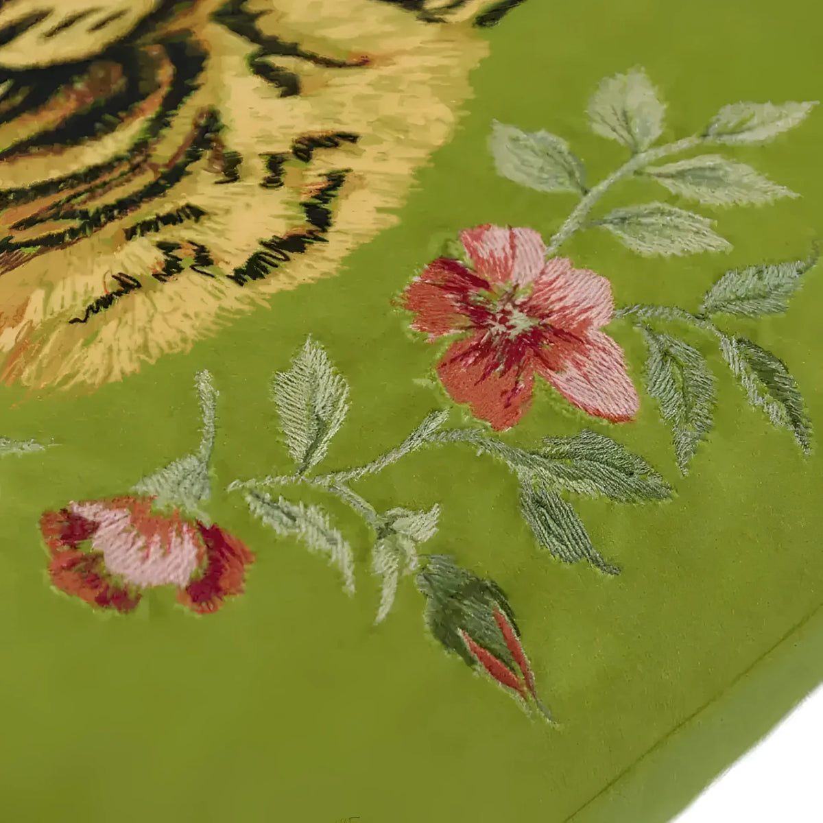 Floral green throw pillow featuring a tiger design and embroidered flowers with tassels, perfect for accenting any room decor.