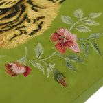 Floral green throw pillow featuring a tiger design and embroidered flowers with tassels, perfect for accenting any room decor.
