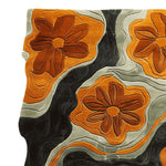 Top view of the Floral Groove Valley Hand Tufted Area Rug showcasing a vibrant abstract design with large orange floral patterns against swirling black and gray waves. This contemporary rug, made from high-quality wool, is perfect for adding a modern touch to living room area rugs.