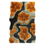 Top view of the Floral Groove Valley Hand Tufted Rug, a contemporary area rug featuring abstract floral patterns in warm shades of orange and black. This wool rug is perfect for adding a stylish touch to your living room decor.