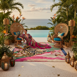 Woman in a colorful dress sitting on a patterned rug with ocean view