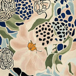 A detailed view of the Floral Matrix Dream Hand Tufted Rug, showcasing its vibrant abstract floral patterns in shades of blue, green, and peach. This contemporary wool area rug is perfect for large living room spaces, adding an artistic touch to any interior.
