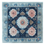 A beautifully designed Floral Mosaic Story Hand Tufted Area Rug, showcasing intricate floral patterns with a rich blend of blue and pink hues. This square rug is perfect for enhancing living room aesthetics, crafted from high-quality wool to add warmth and elegance. Ideal as a centerpiece, it's a stunning example of area rugs for living room spaces.