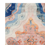 This is a close-up view of the Floral Muse Reverie Hand Tufted Area Rug, showcasing an intricate floral design with vibrant colors. The large living room rug features a blend of blues, pinks, and oranges, making it a perfect wool rug for adding elegance to any space. Ideal for those seeking an 8x10 floral rug to enhance their decor.