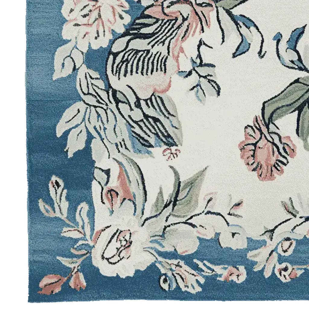 Close-up of the Floral Reverie Hand Knotted Rug, showcasing a vibrant floral design with soft pink and blue hues, perfect as a square area rug for living rooms. This wool rug features intricate patterns ideal for adding elegance to any space.