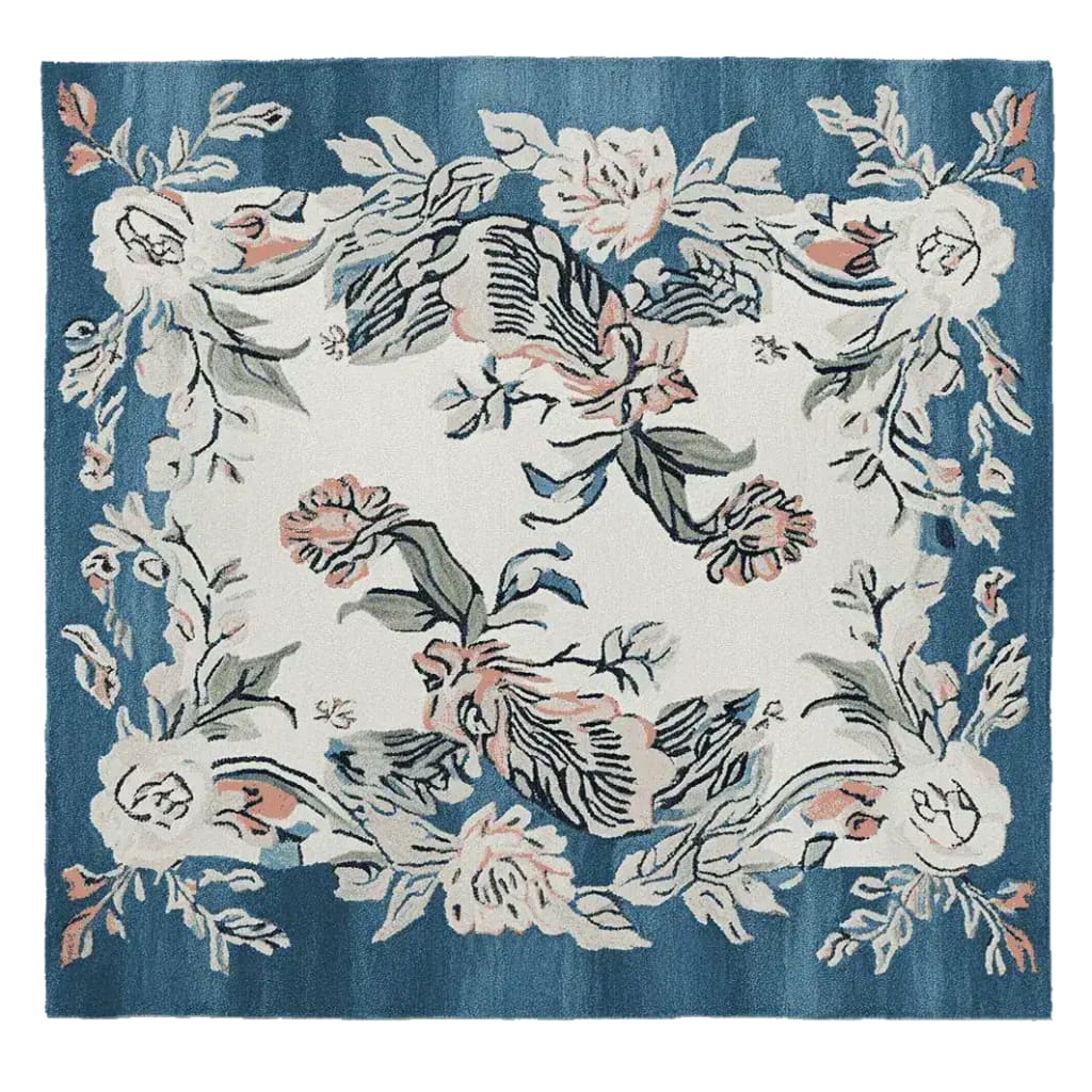 Square wool area rug featuring a floral design with soft pink and white flowers on a deep blue background, perfect for enhancing living room decor.