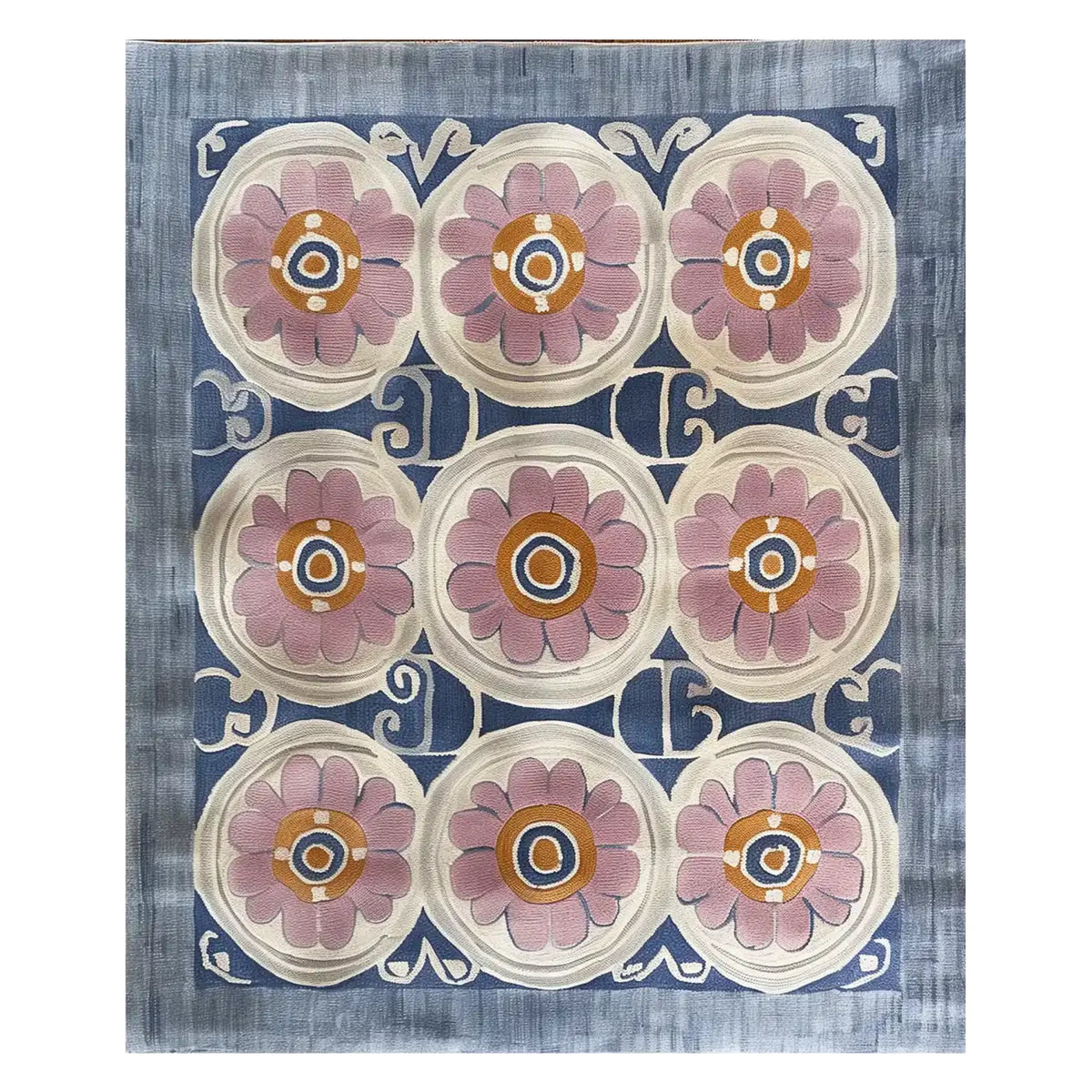 Top view of the Floral Revival Hand Tufted Wool Rug, showcasing its intricate design with large pink floral patterns against a blue and cream background. Perfect for adding a touch of elegance to any living room, this 8x10 area rug is crafted from high-quality wool.