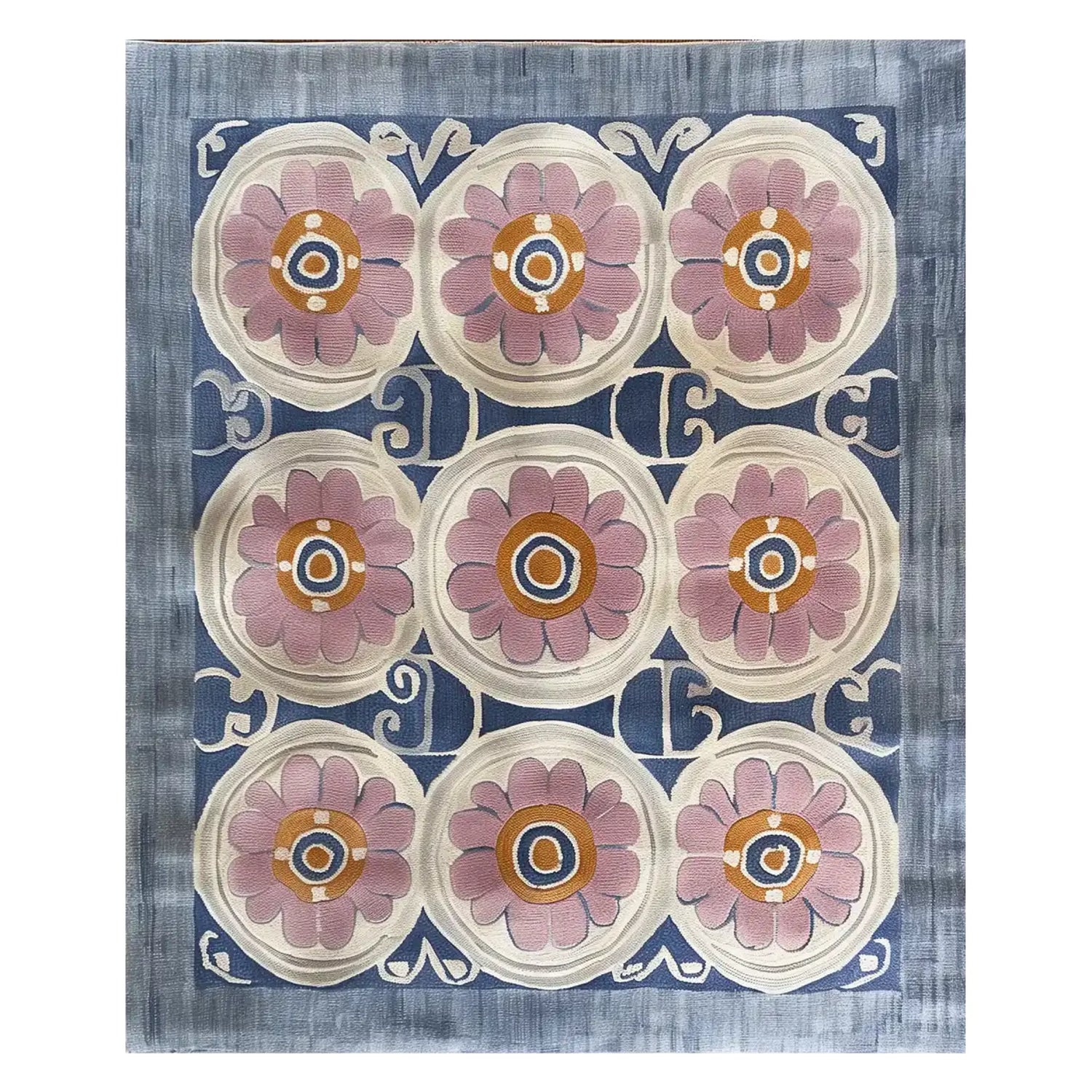 Top view of the Floral Revival Hand Tufted Wool Rug, showcasing its intricate design with large pink floral patterns against a blue and cream background. Perfect for adding a touch of elegance to any living room, this 8x10 area rug is crafted from high-quality wool.