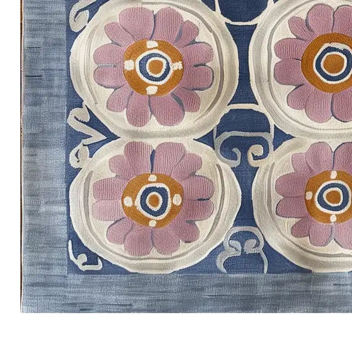 Top view of a Floral Revival Hand Tufted Wool Rug, showcasing a vibrant floral pattern with pink and orange flowers on a rich blue background. Perfect as a stylish 8x10 area rug for living rooms, adding a touch of elegance and warmth.