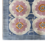 Top view of a Floral Revival Hand Tufted Wool Rug, showcasing a vibrant floral pattern with pink and orange flowers on a rich blue background. Perfect as a stylish 8x10 area rug for living rooms, adding a touch of elegance and warmth.