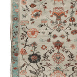 Close-up of a Floral Scroll Harmony Hand Knotted Area Rug, showcasing intricate floral patterns in warm tones on a soft wool texture. Perfect for adding elegance to living room rugs 8x10. This floral rug beautifully combines traditional design with modern aesthetics.