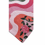 Close-up of a colorful floral-patterned rug with pink and red colors.