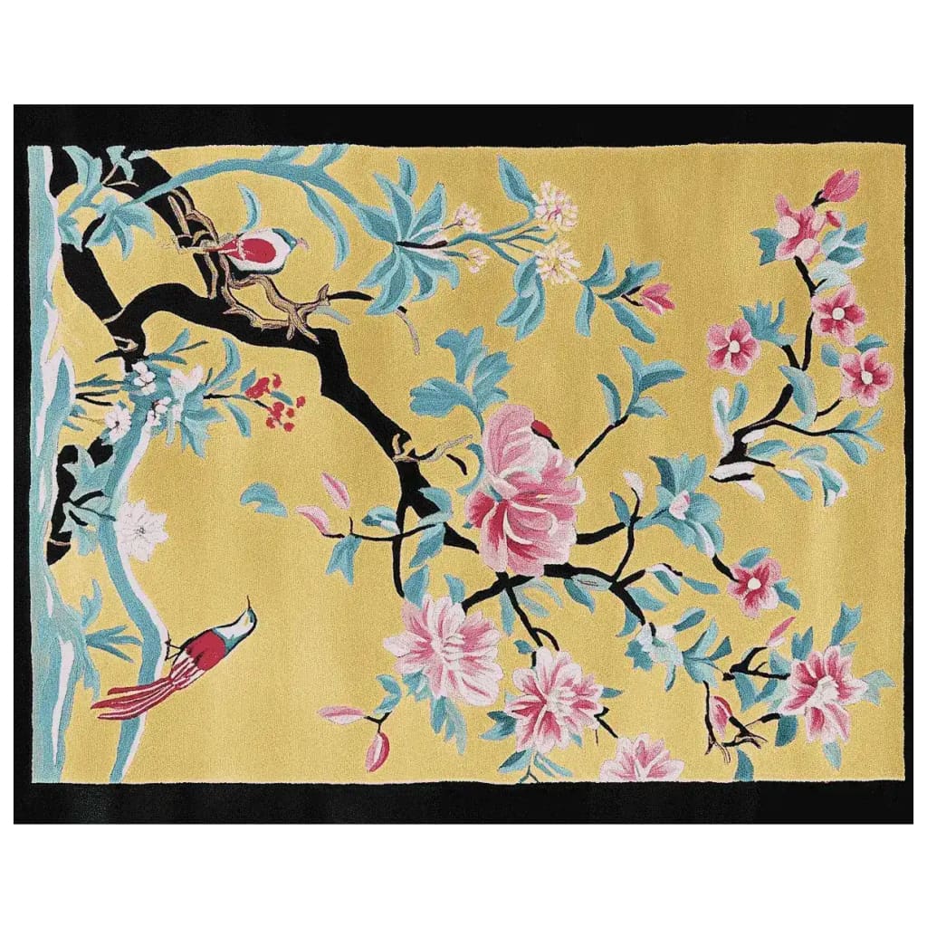 A vibrant area rug featuring a floral design with branches and blossoms on a warm yellow background. Perfect for adding a touch of elegance to living room spaces, this hand-tufted wool rug enhances the beauty of any home decor.