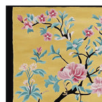 Vibrant hand-tufted area rug with a floral design, featuring pink and blue blossoms on a yellow background. Perfect for adding a touch of elegance to living room spaces, this wool rug complements any decor style.