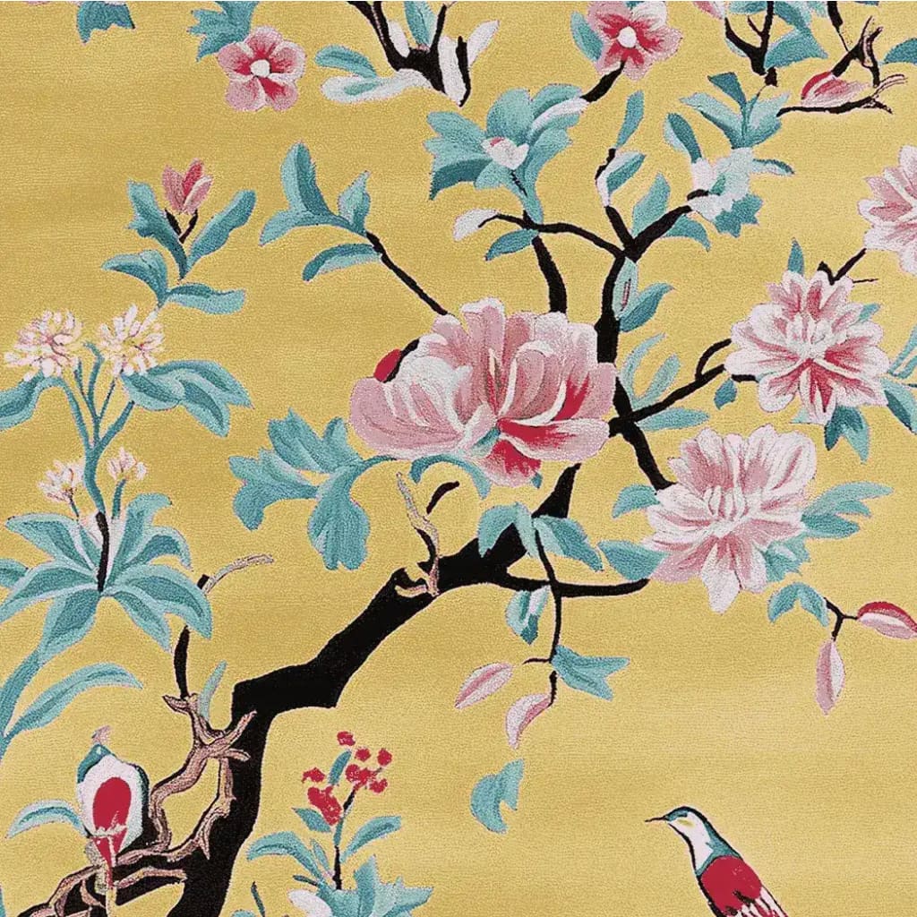 This vibrant area rug showcases a beautiful floral design with pink and red blossoms and delicate birds on a sunny yellow background. Perfect for adding a pop of color to your living room, this hand-tufted wool rug brings elegance and charm to any space.