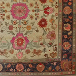 This Flower Enchantment Hand Knotted Area Rug features an intricate floral design with vibrant pink, red, and orange blossoms against a neutral backdrop, perfect for large living room spaces. The vintage-inspired pattern brings a touch of Persian elegance, making it an ideal choice for those seeking a classic floral rug.