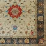 The Flowering Oasis Hand Knotted Area Rug showcases a stunning vintage Persian design, perfect for large living room spaces. This floral rug features intricate patterns with a bold red medallion at its center, surrounded by a harmonious blend of beige, blue, and earthy tones, ideal for adding elegance to any living room area.