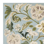 This beautiful area rug features an intricate floral design in soft greens and whites against a calming blue background. Perfect for those seeking a wool rug that adds a contemporary touch to any large living room. Ideal for creating a serene atmosphere, this hand tufted rug is a stylish choice for your rugs for living room collection.