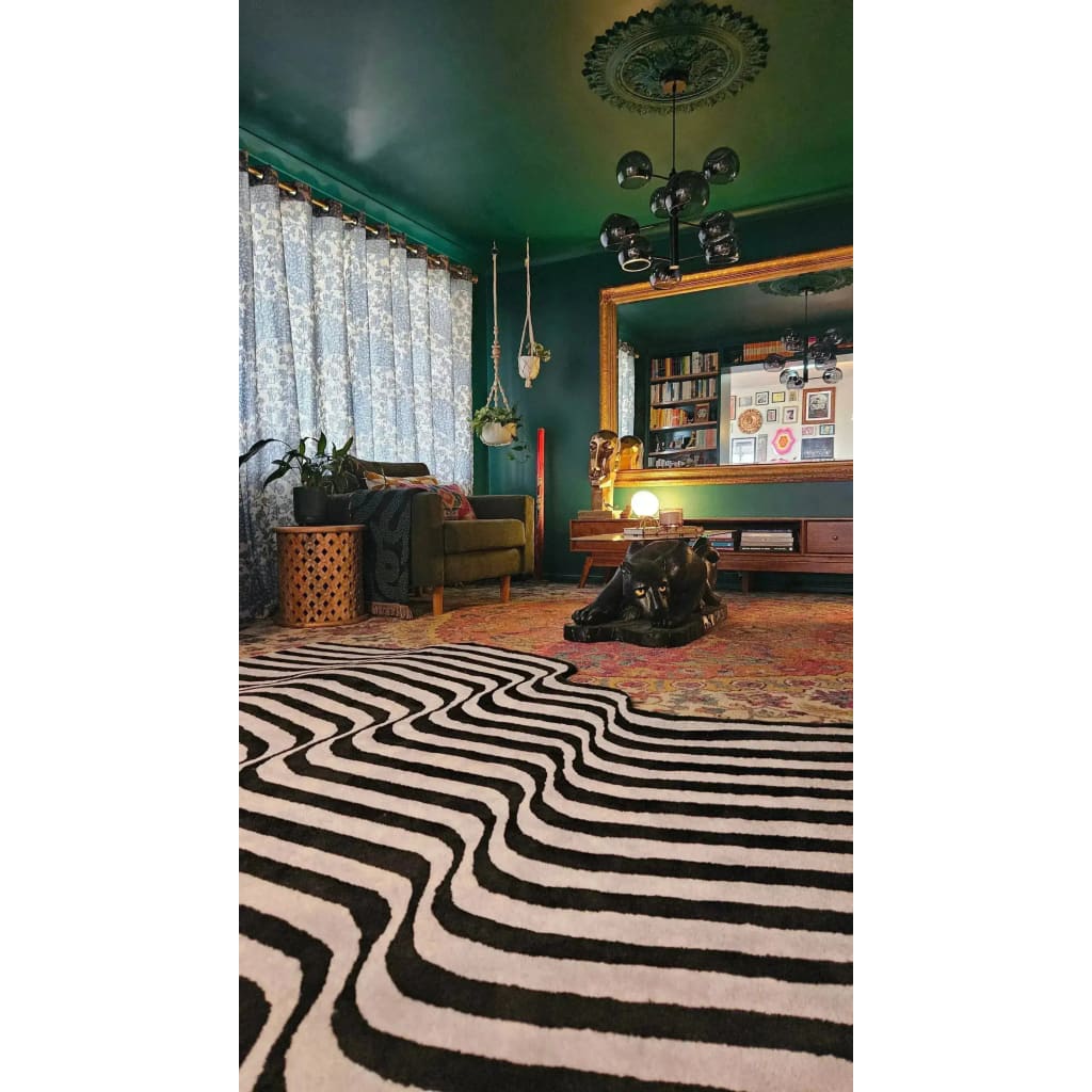 A stylish living room featuring the Flowing Illusion Black and Gray Wool Runner Rug. The area rug showcases a dynamic black and gray wave pattern, perfect for contemporary spaces. Ideal for use as a vintage rug or hallway runner rug, it complements the elegant decor of a dining room or large living room. This wool rug adds a touch of sophistication to kitchen runner rugs or bathroom runner rug settings.