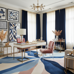 Modern office with geometric carpet, blue and white curtains, and decorative elements.