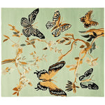 A beautifully designed area rug featuring a hand-tufted pattern of butterflies and branches on a soft green background. This wool rug is perfect for adding a touch of elegance to any living room. Ideal as a large living room rug, it combines art and comfort seamlessly.