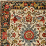 A beautifully intricate hand-knotted area rug with a vintage floral design, perfect for adding a touch of elegance to any living room. This Persian-inspired rug features detailed patterns of blooming flowers and colorful birds against a warm, neutral background. Ideal for an 8x10 space, this floral rug enhances the aesthetic of any area it graces.