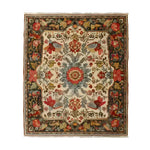 A beautifully intricate Fluttering Bloom hand-knotted area rug showcasing a vintage Persian design with vibrant floral patterns. This elegant 8x10 rug is perfect for adding a touch of sophistication to any living room space.