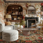 Luxurious living room with floral rug, wallpaper, bookshelves, and a fireplace.