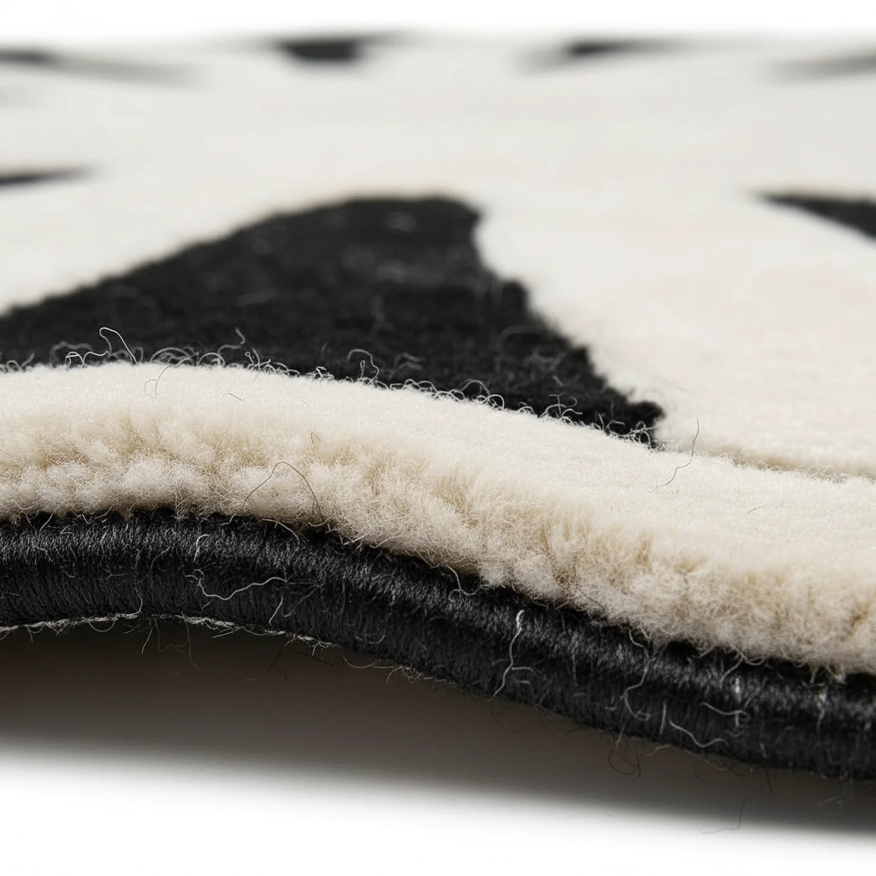 Close-up of a black and white patterned rug with visible texture.