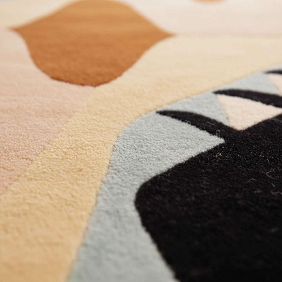Close-up of a multicolored geometric patterned rug.
