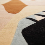 Close-up of a multicolored geometric patterned rug.