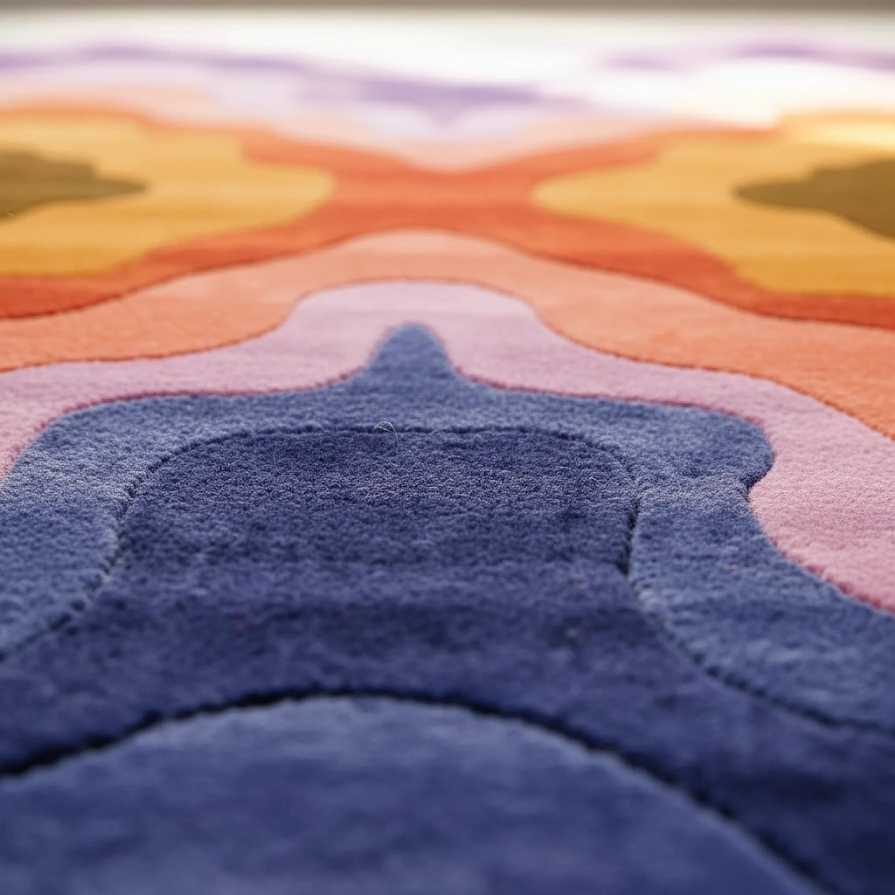 Close-up of a textured rug with colorful patterns