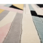 Close-up of a textured rug swatch with geometric pattern